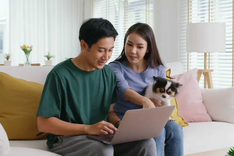 How Rising Home Prices Impact Your Buying Power 1 Couple sitting on couch looking at at laptop